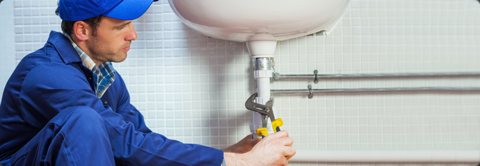 Plumber fixing bathroom sink