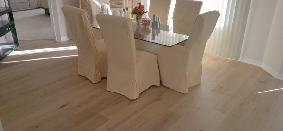 Chappie S Carpet Floors Inc Flooring Sarasota Fl Pale Hardwood Floor In A Dining Room With Glass Top Table And Chairs White Cover
