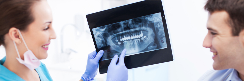 Dentist showing x-rays to patient