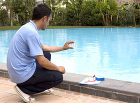 Man checking the water in a pool