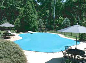 A pool covered by a mesh pool cover